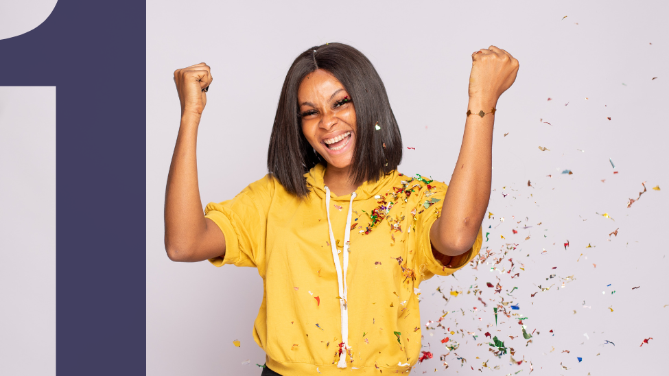 African American woman celebrates with confetti