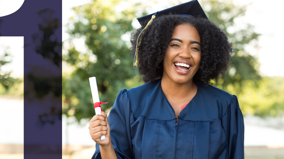 Happy young African American woman wearing graduation cap and gown holding a rolled diploma