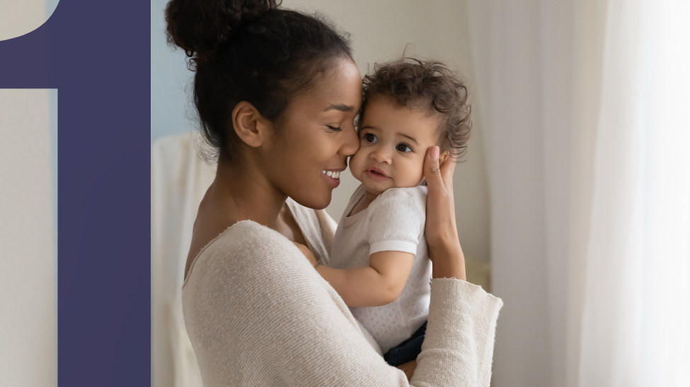 Happy African American mom holding cute baby and giving snuggles