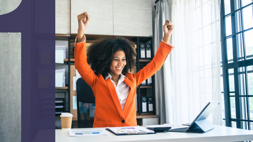 Woman executive cheering at her desk